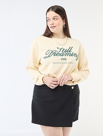 Jupe short avec pan croisé avec bouton fantaisie