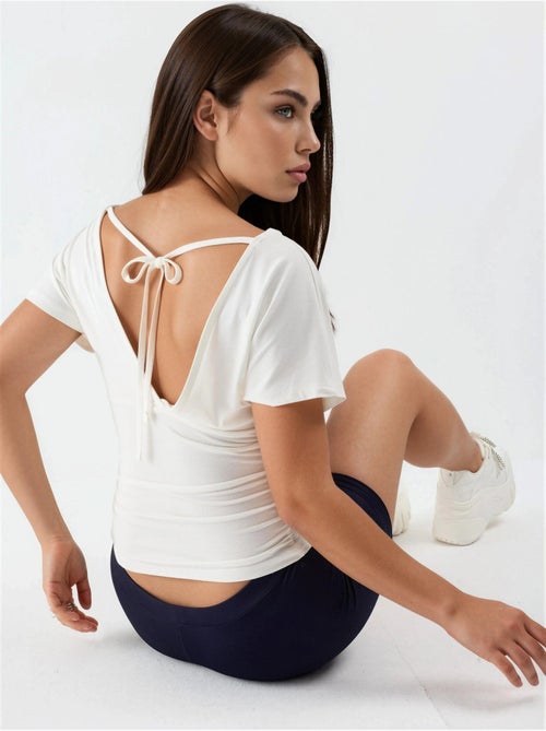 Blouse à col v avec détail nœud busem - Kiabi Blouse à col v avec détail nœud busem - Kiabi