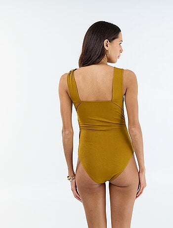 Body met diepe ruguitsnijding en goudkleurig detail