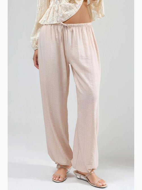 Broek met elastische taille en strikdetail busem - Kiabi Broek met elastische taille en strikdetail busem - Kiabi