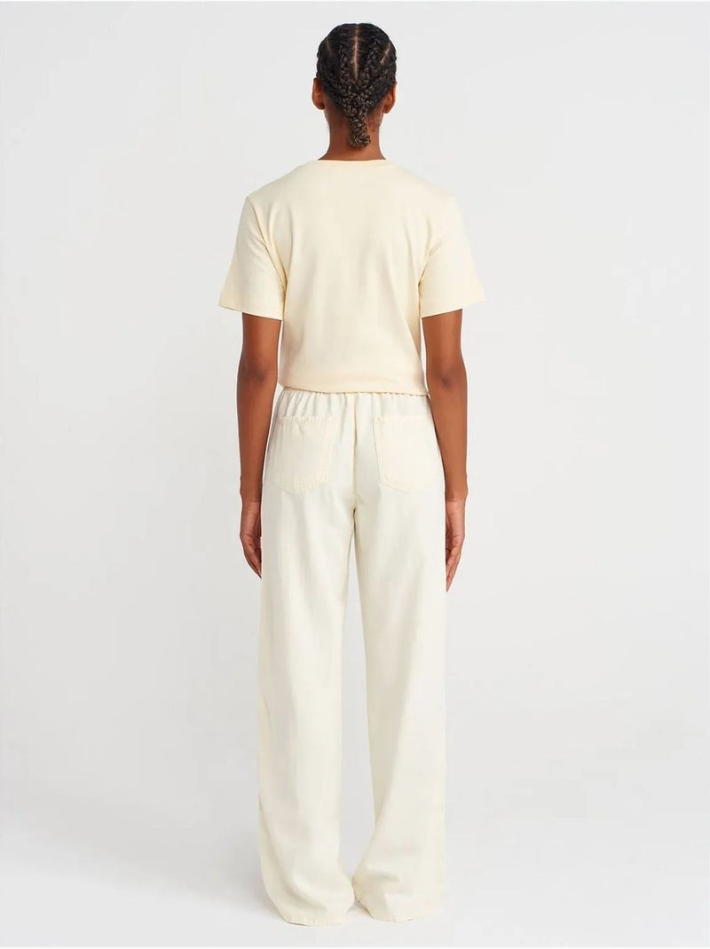 Broek met hoge taille, wijde pijp en strik dilvin Crème - Kiabi