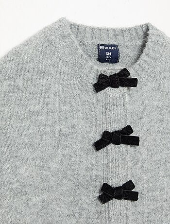 Cape van tricot met fluwelen strikken