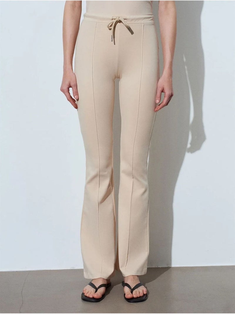 Flared jerseybroek met middelhoge taille en trekkoord dilvin Klei-beige - Kiabi