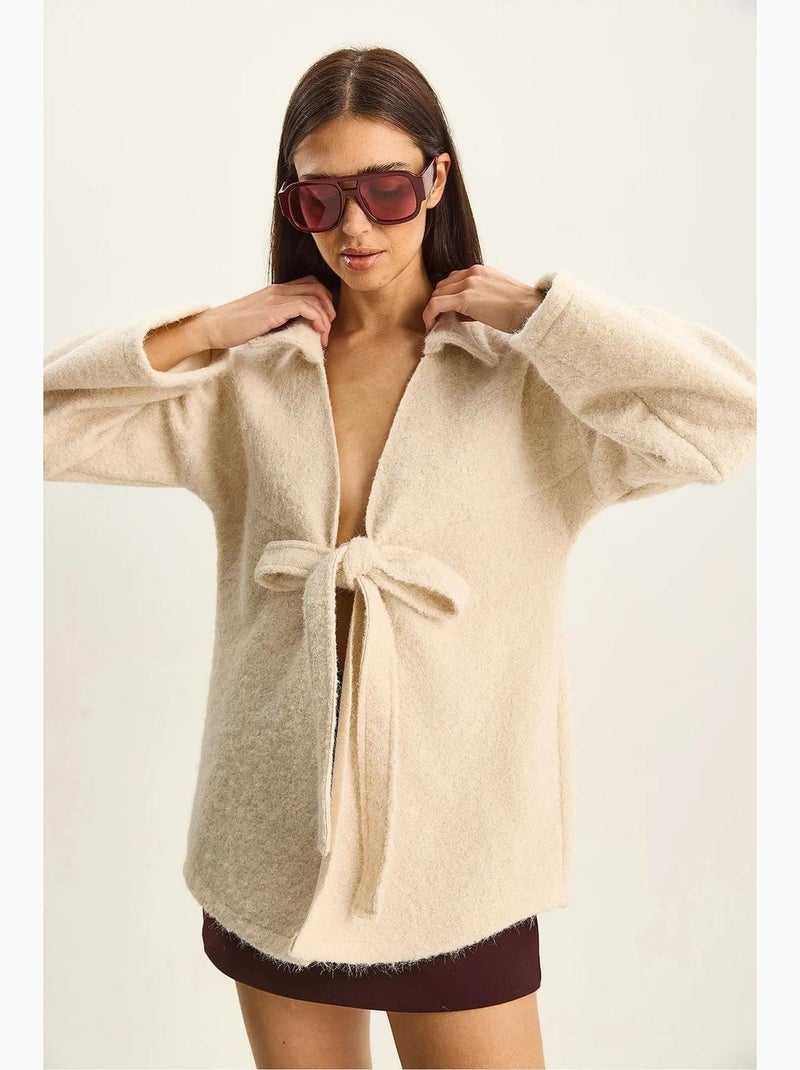 Getextureerd oversized vest met v-hals en striksluiting lucci Ivoor - Kiabi