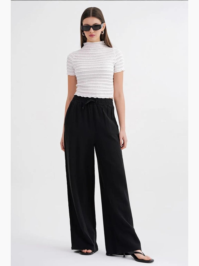 High waist broek van getextureerde mousselin mixray Zwart - Kiabi