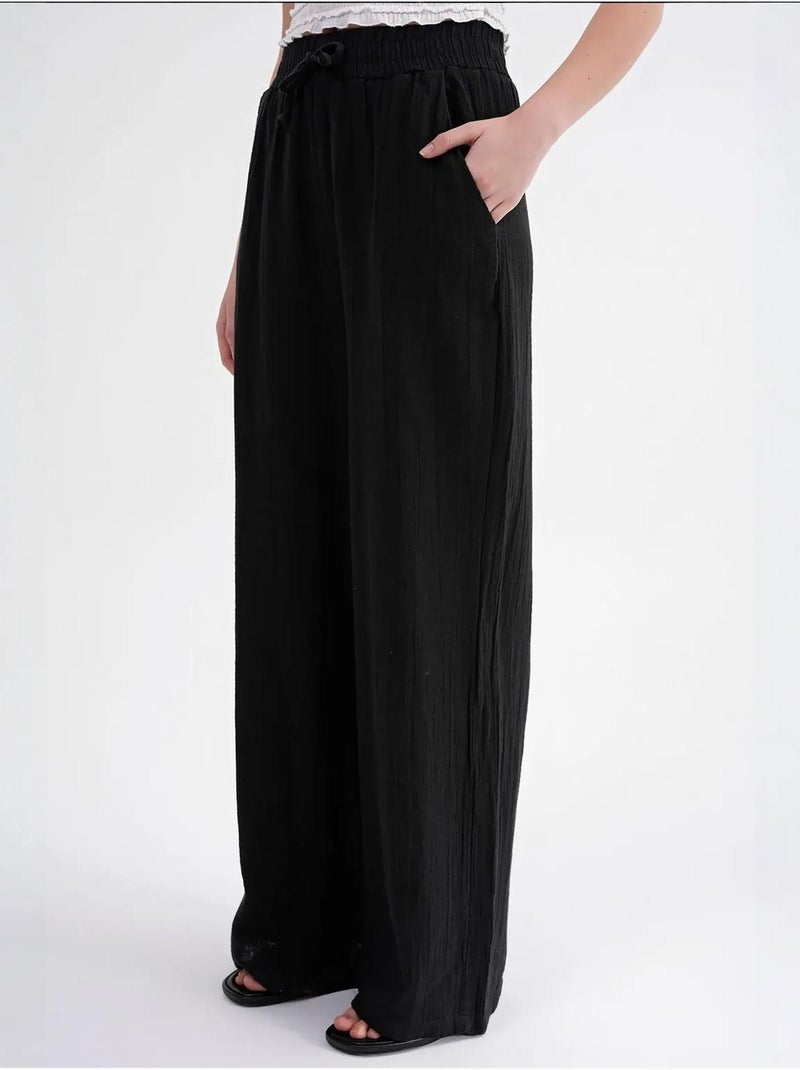 High waist broek van getextureerde mousselin mixray Zwart - Kiabi