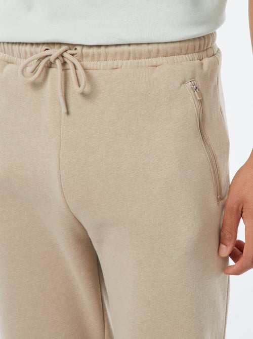 Jogging en molleton gratté avec 2 poches zippées - Kiabi