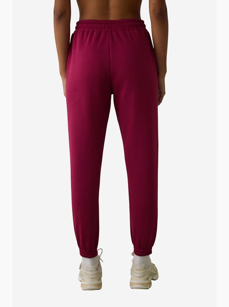 Joggingbroek met hoge taille en strikdetail, zacht geruwd penti Magenta - Kiabi