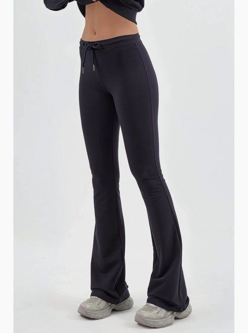Joggingbroek met uitlopende pijp, halfhoge taille en trekkoord busem - Kiabi Joggingbroek met uitlopende pijp, halfhoge taille en trekkoord busem - Kiabi