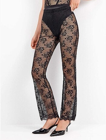 Lange elastische broek van delicate en transparante bloemenkant