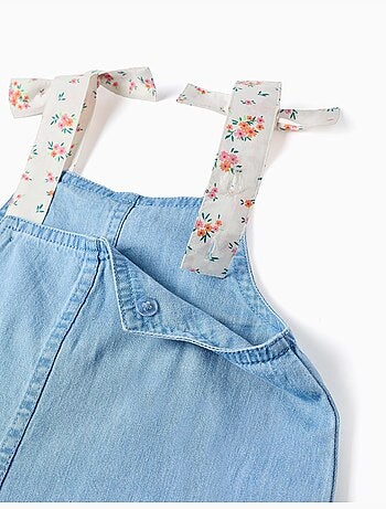 Mouwloze denim jumpshort met bloemenbandjes