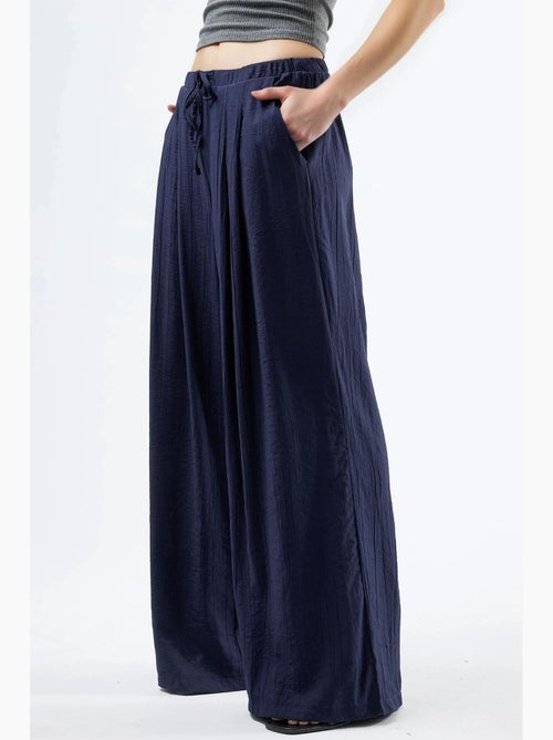 Pantalon à jambes larges et cordon de serrage busem - Kiabi Pantalon à jambes larges et cordon de serrage busem - Kiabi
