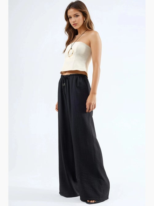 Pantalon à jambes larges et taille élastiquée avec cordon de serrage et poches busem - Kiabi Pantalon à jambes larges et taille élastiquée avec cordon de serrage et poches busem - Kiabi