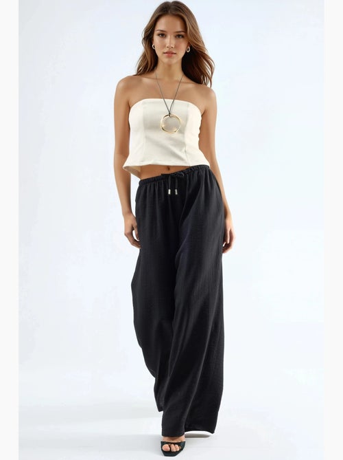 Pantalon à jambes larges et taille élastiquée avec cordon de serrage et poches busem - Kiabi Pantalon à jambes larges et taille élastiquée avec cordon de serrage et poches busem - Kiabi