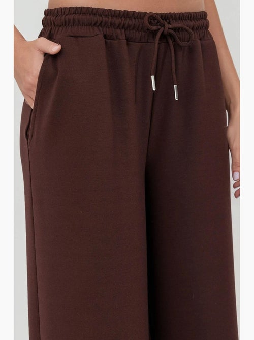 Soft modal touch sweatpants met wijde pijpen hiccup - Kiabi Soft modal touch sweatpants met wijde pijpen hiccup - Kiabi