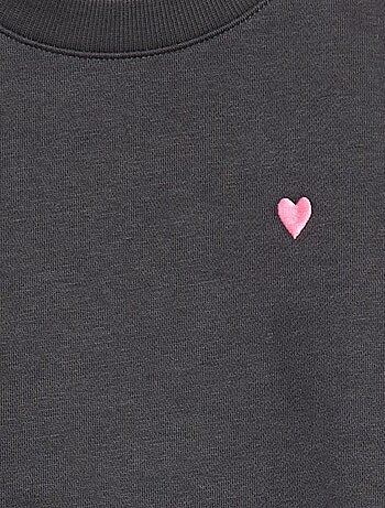 Sweater van joggingstof met borduursel en fronsjes op de schouder