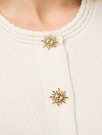 Top sans manches avec boutons dorés