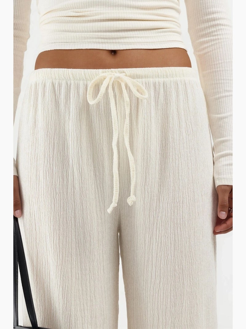Wijde broek met taillekoord busem Crème - Kiabi