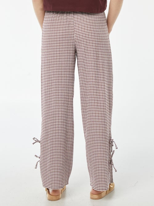 Wijde broek van gekreukte stof met strikjes - Kiabi